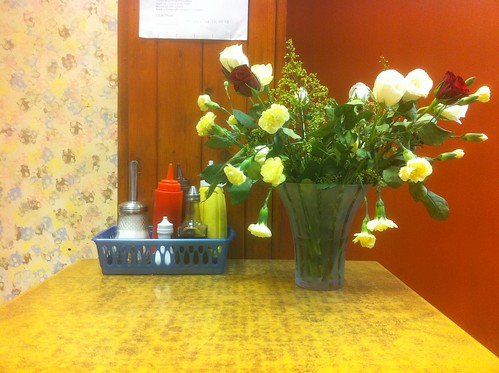 Two men talking about work over lunch